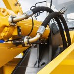 hydraulics tractor yellow. focus on the hydraulic pipes